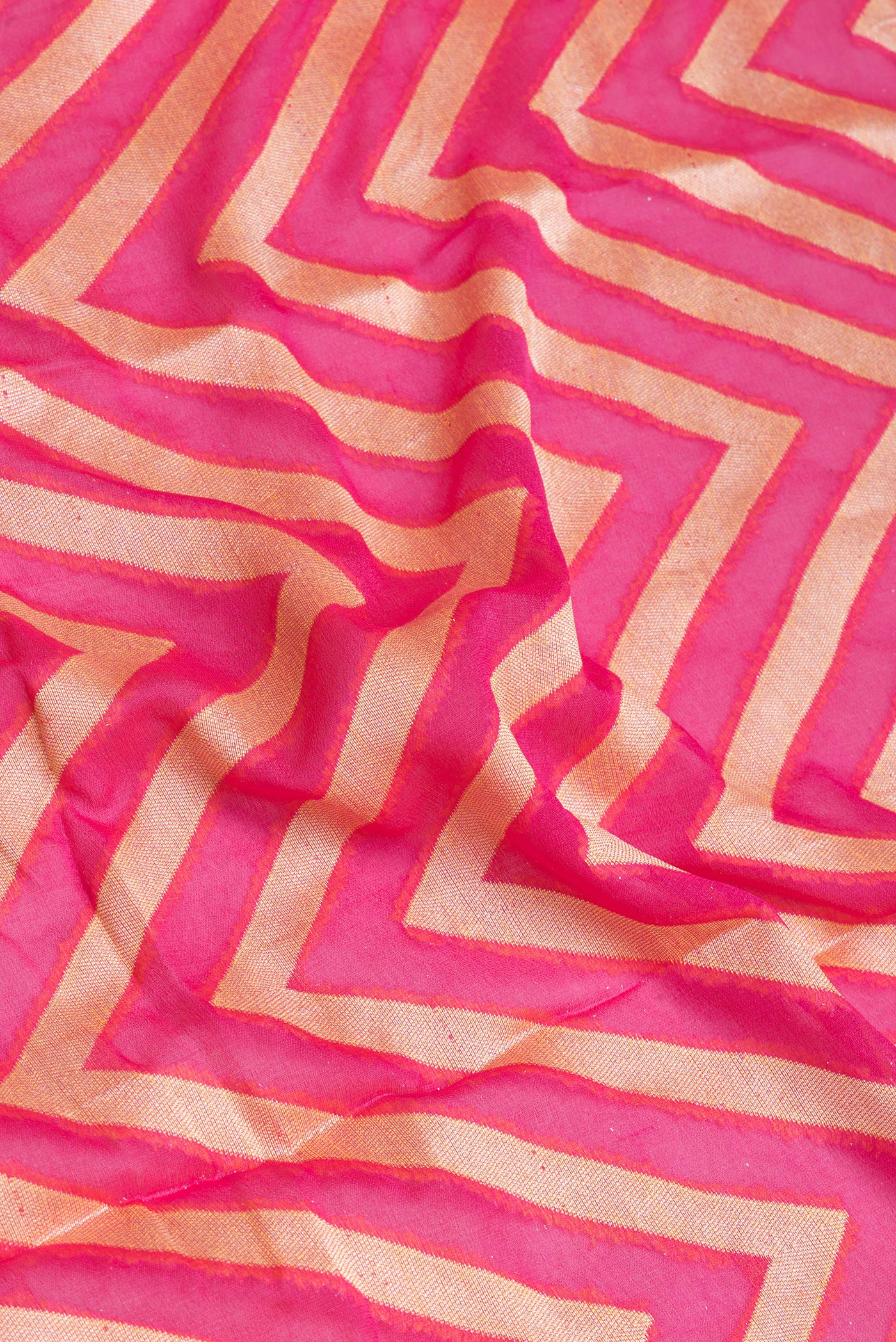 Close up of Pink Banarasi Georgette Saree with Zig Zag design on the body and Fancy Border.  displaying folds