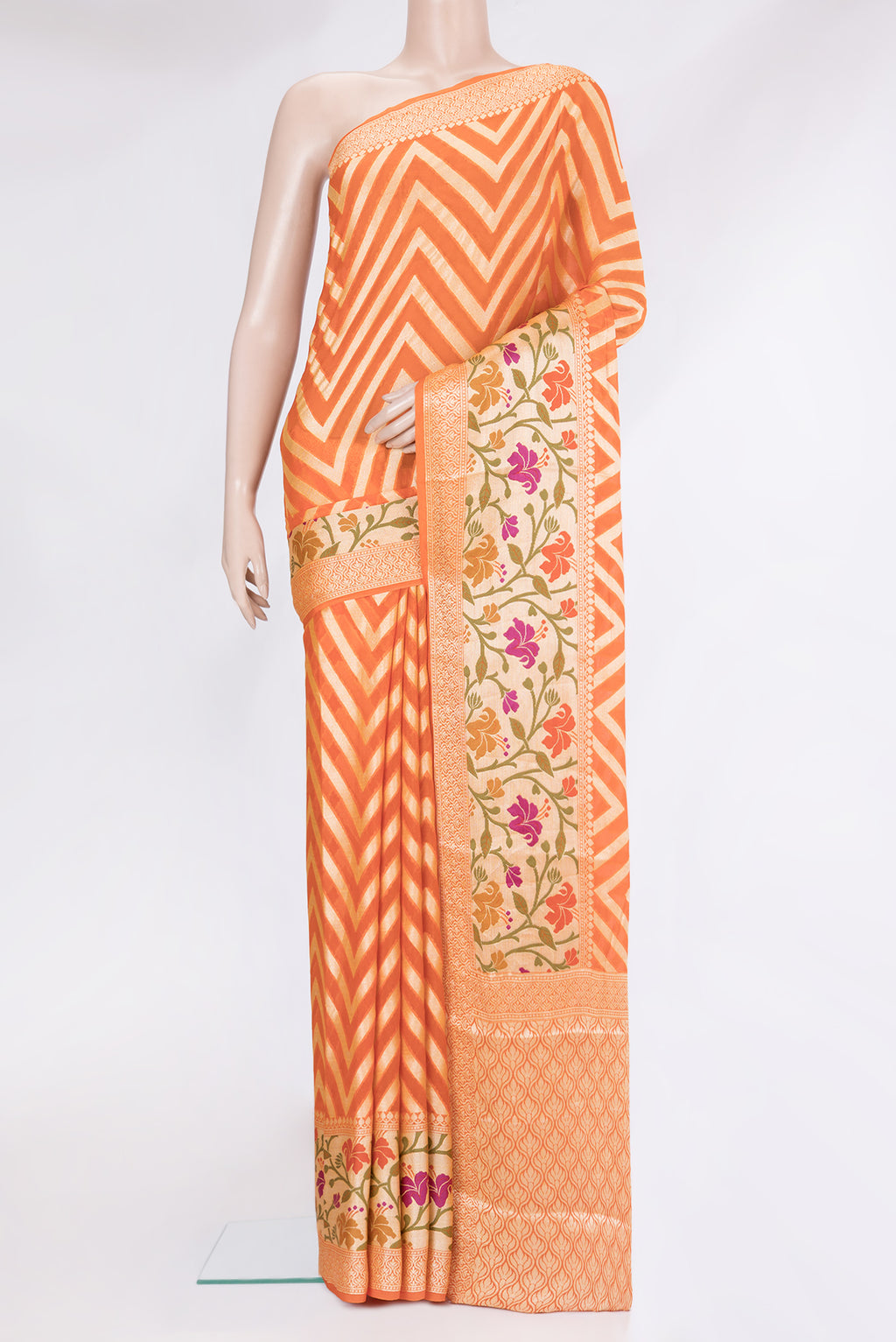 Orange Banarasi Georgette Saree with Zig Zag design on the body and Fancy Border.  displayed on a mannequin