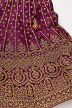 Detailed shot of Burgundy Banarasi Silk Womens Lehenga set featuring Embroidered Choli paired with Burgundy Embroidered Skirt with Embroidered Border and a Embroidered dupatta in Burgundy