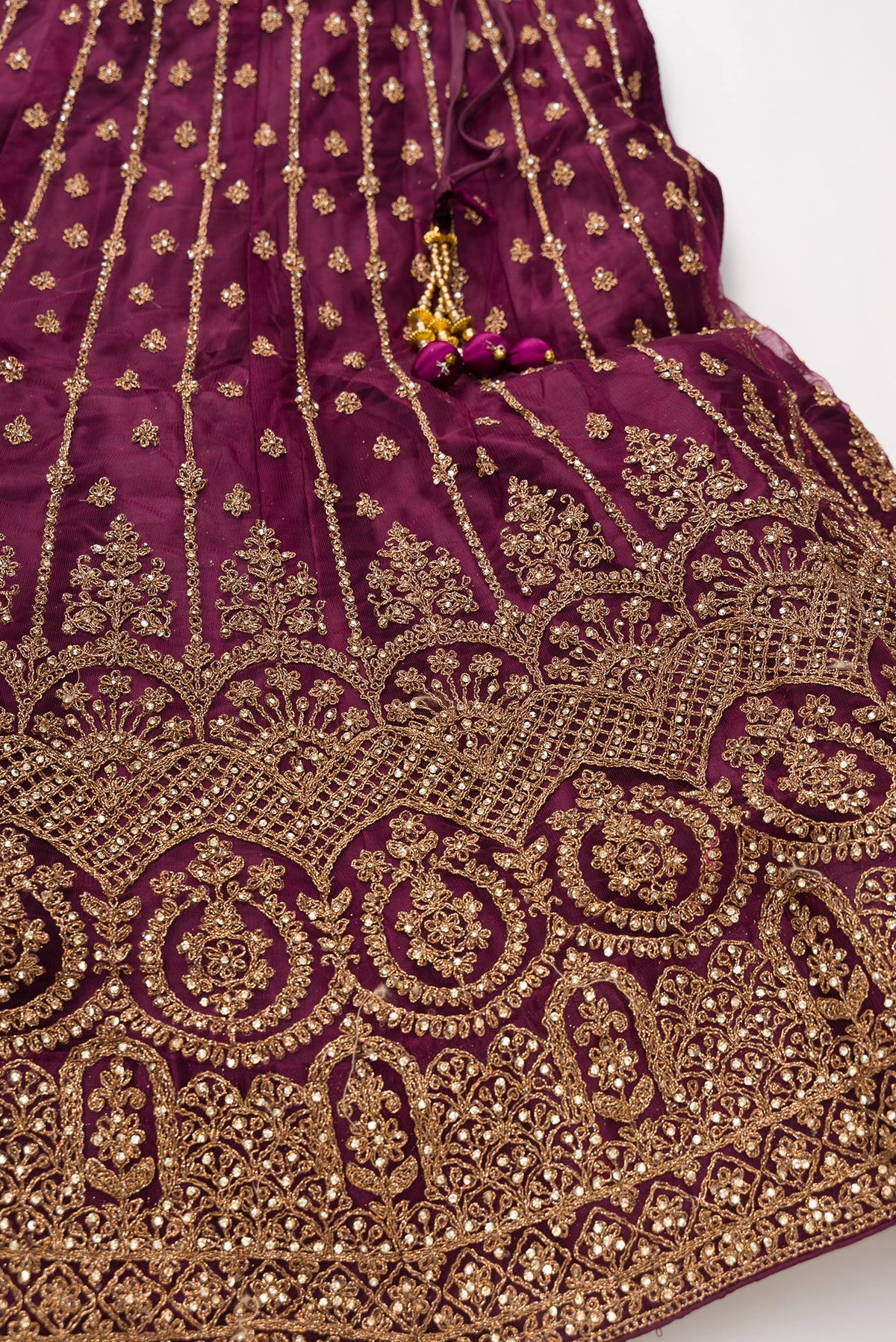 Detailed shot of Burgundy Banarasi Silk Womens Lehenga set featuring Embroidered Choli paired with Burgundy Embroidered Skirt with Embroidered Border and a Embroidered dupatta in Burgundy