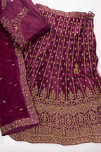 Flat lay of Burgundy Banarasi Silk Womens Lehenga set featuring Embroidered Choli paired with Burgundy Embroidered Skirt with Embroidered Border and a Embroidered dupatta in Burgundy
