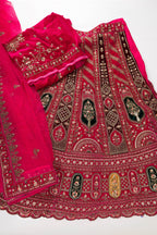 Flat lay of Dark Pink Raw Silk Womens Lehenga set featuring Embroidered Choli paired with Dark Pink Embroidered Skirt with Embroidered Border and a Embroidered dupatta in Dark Pink
