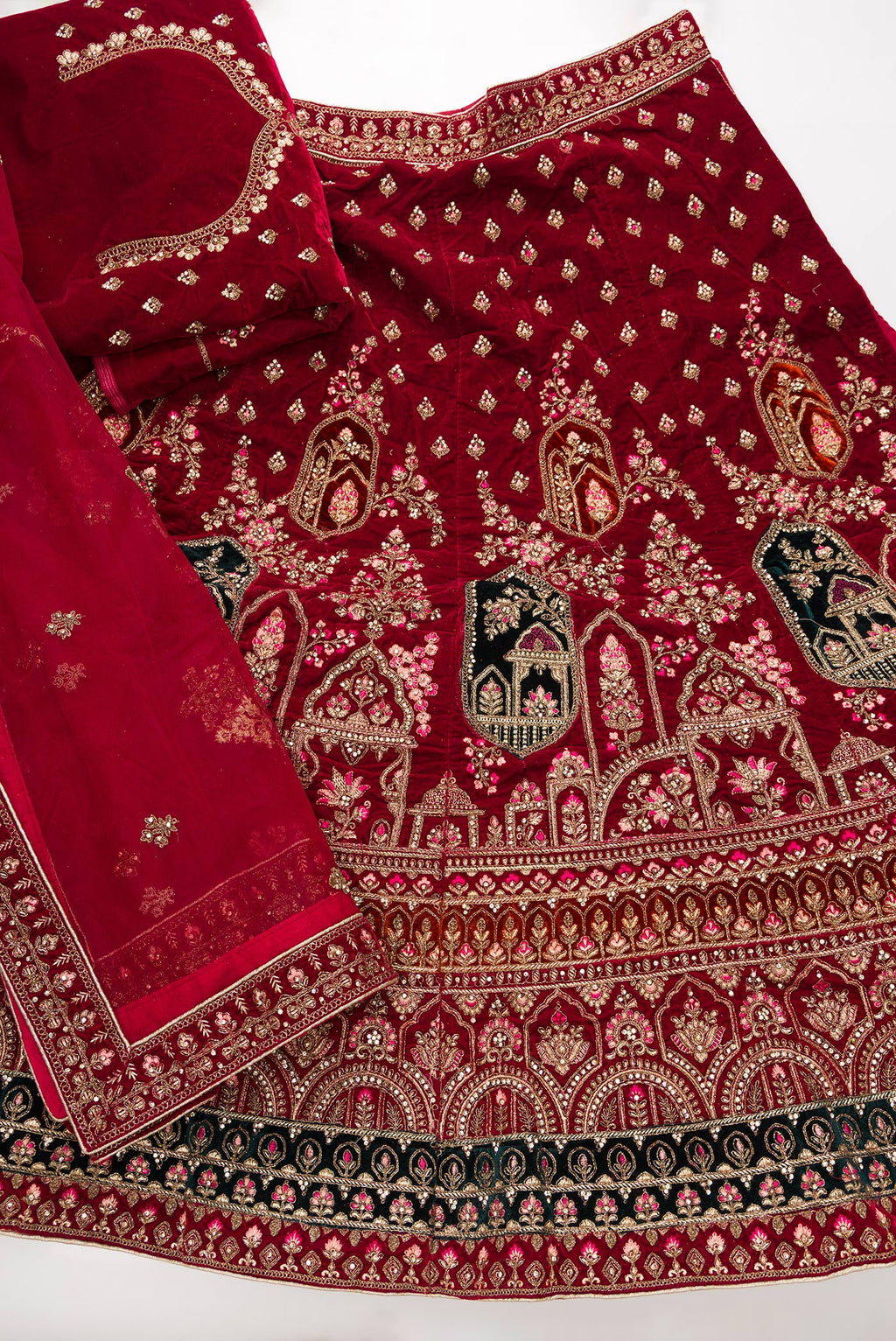 Flat lay of Dark Pink Banarasi Silk Womens Lehenga set featuring Embroidered Choli paired with Dark Pink Embroidered Skirt with Embroidered Border and a Embroidered dupatta in Dark Pink