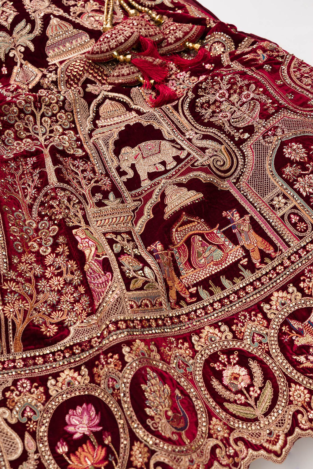 Detailed shot of Maroon Banarasi Silk Womens Lehenga set featuring Embroidered Choli paired with Maroon Embroidered Skirt with Embroidered Border and a Embroidered dupatta in Maroon