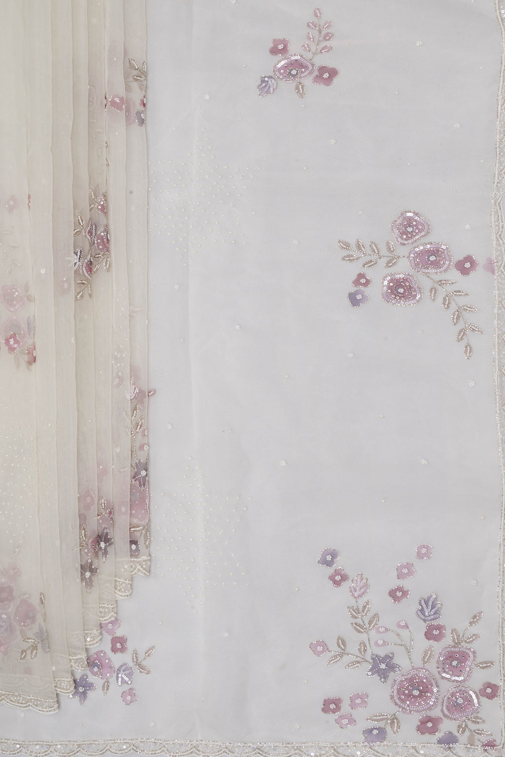 Pleats and pallu of Off White Organza Saree with Embroidery on the body and Embroidery Border. 