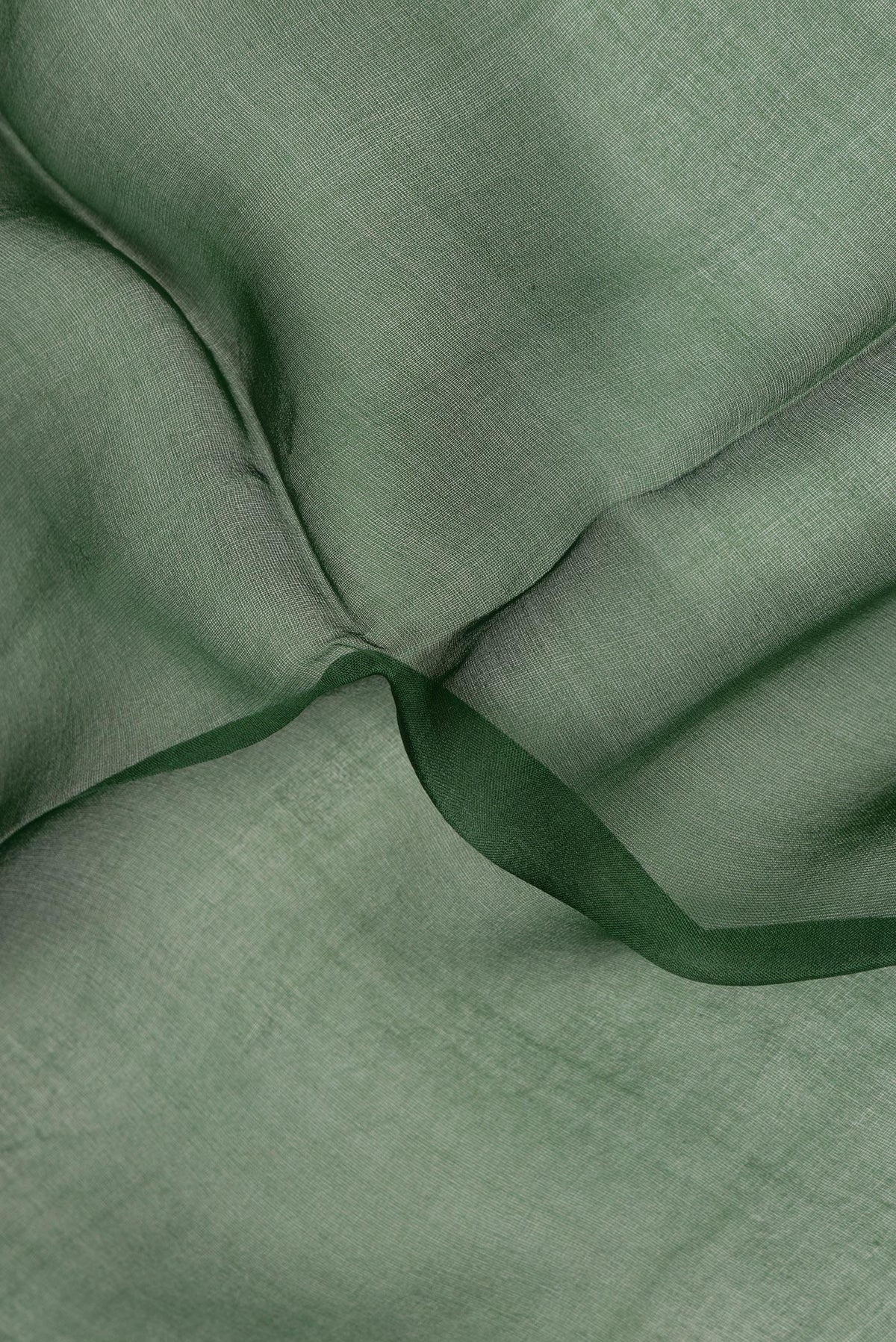 Close up of Pure Silk Bottle Green Dual Tone Tussar Saree with Plain Body and Fancy Border.  displaying folds