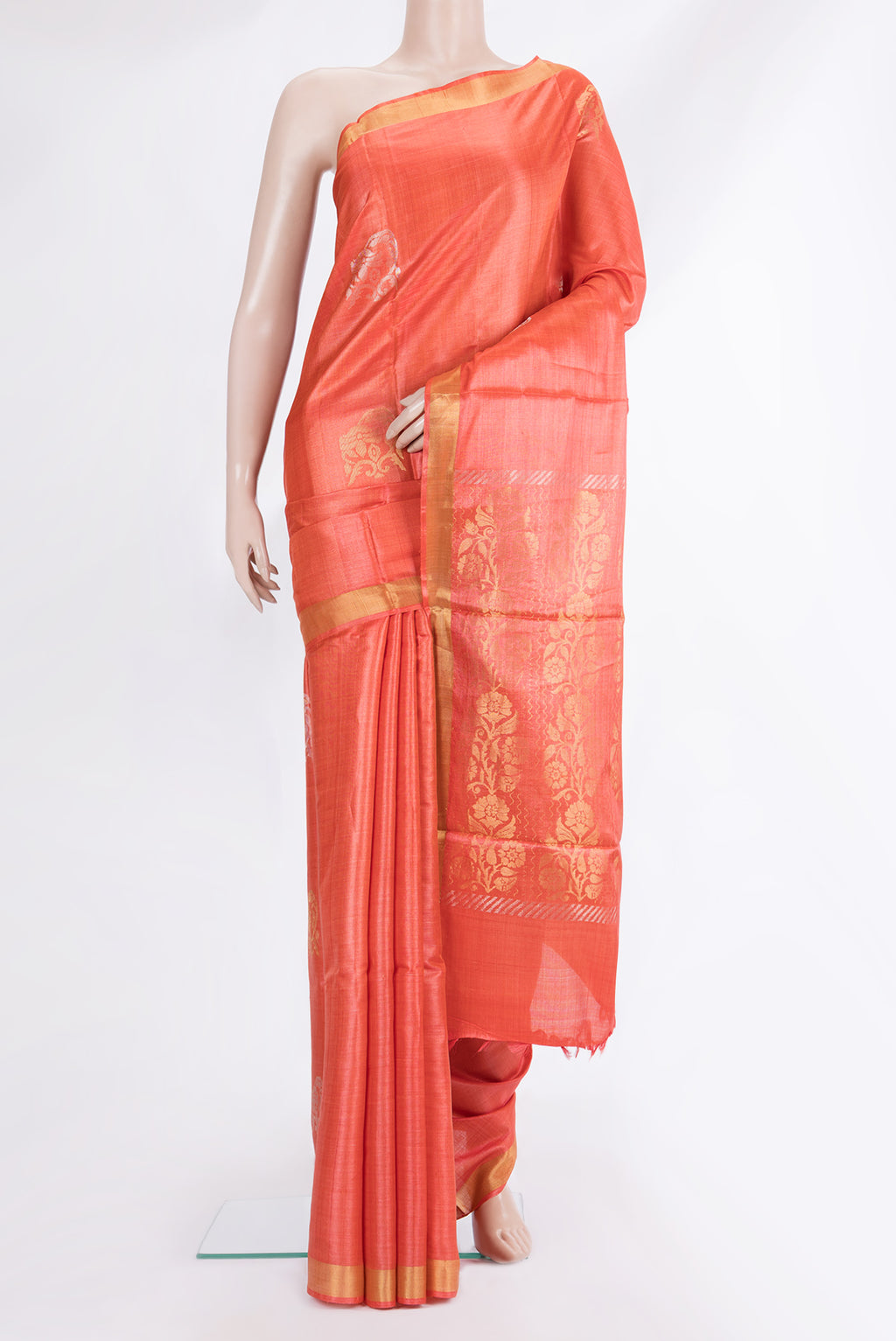 Orange Tussar Saree with Zari And Thread Butta on the body and Zari Border.  displayed on a mannequin