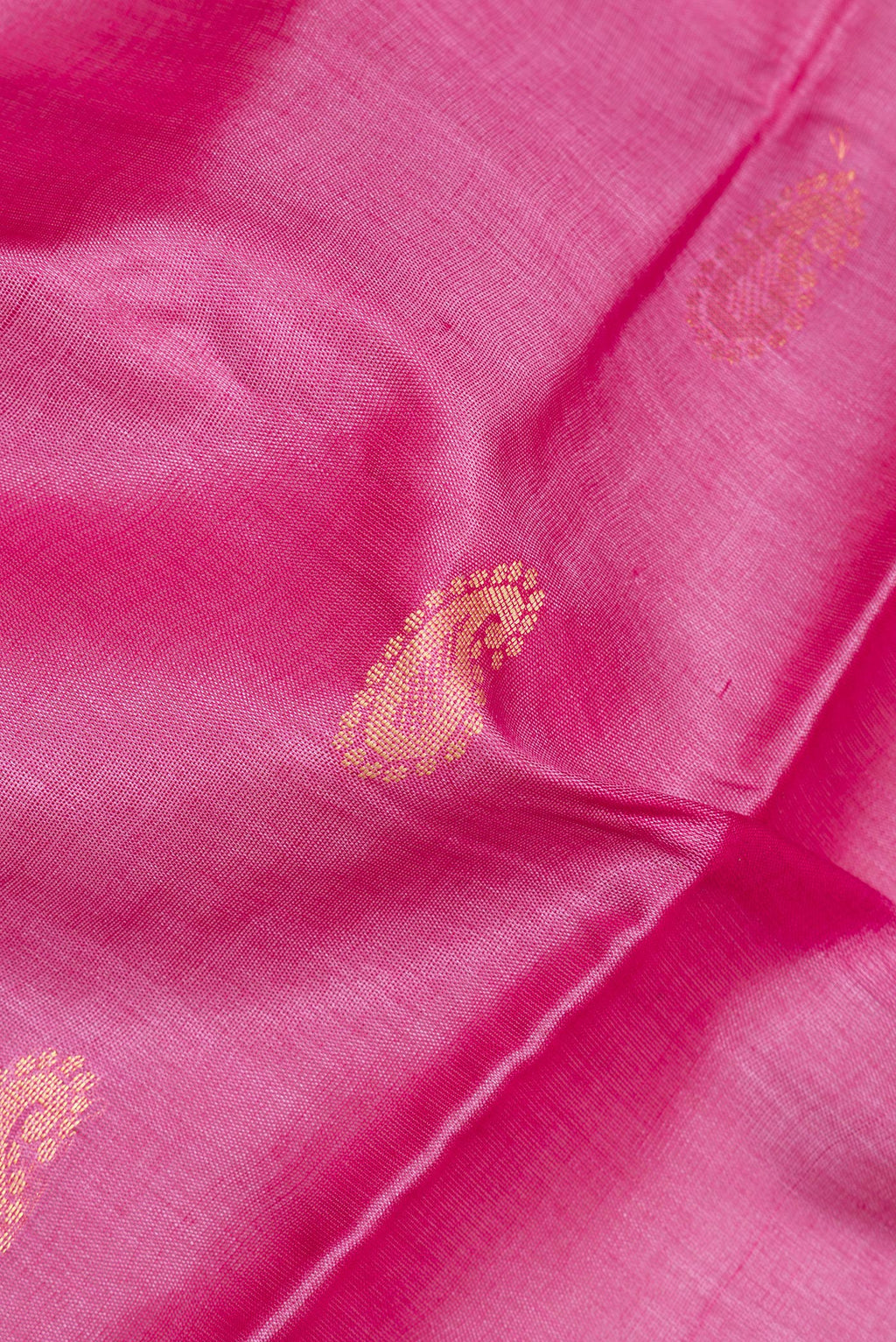 Close up of Pink Tussar Saree with Zari And Thread Butta on the body and Plain Border.  displaying folds
