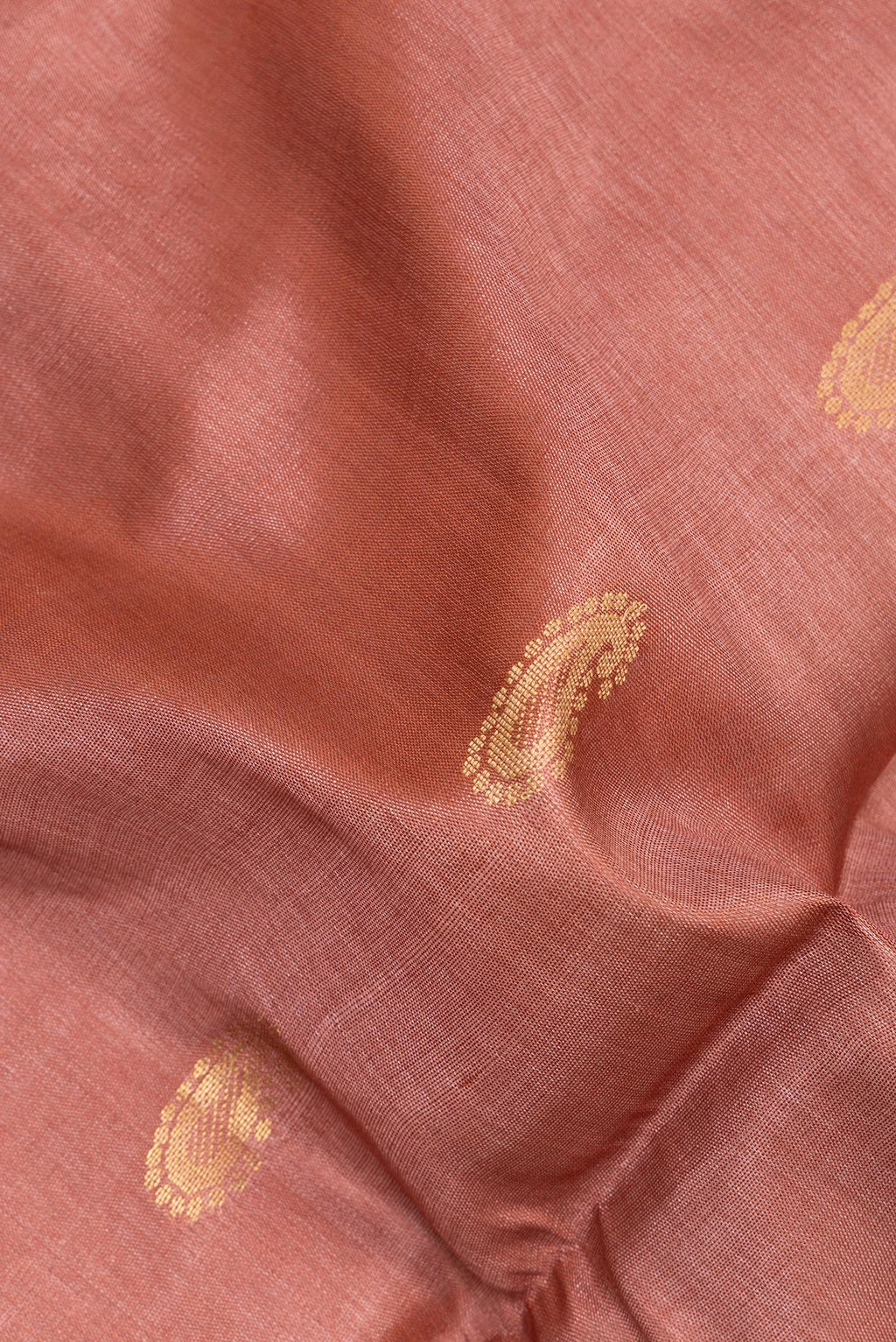 Close up of Pure Silk Brown Tussar Saree with Zari And Thread Butta on the body and Plain Border.  displaying folds
