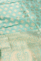 Detailed shot of Light Green Banarasi Silk Womens Lehenga set featuring Zari Brocade Choli paired with Light Green Zari Brocade Skirt with Zari Border and a Zari Butta dupatta in Light Green