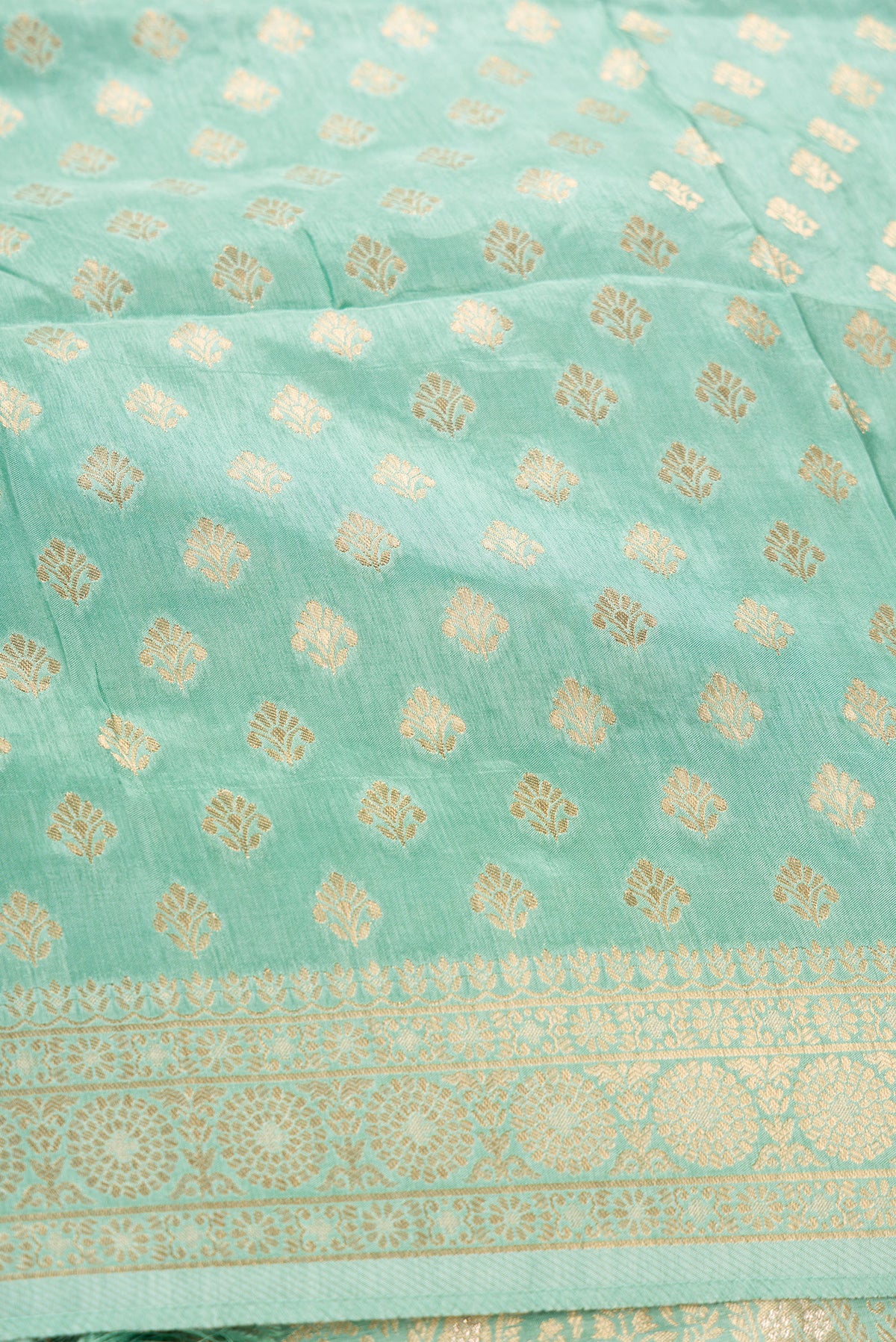 Close up blouse image of Light Green Banarasi Silk Womens Lehenga set featuring Zari Brocade Choli paired with Light Green Zari Brocade Skirt with Zari Border and a Zari Butta dupatta in Light Green