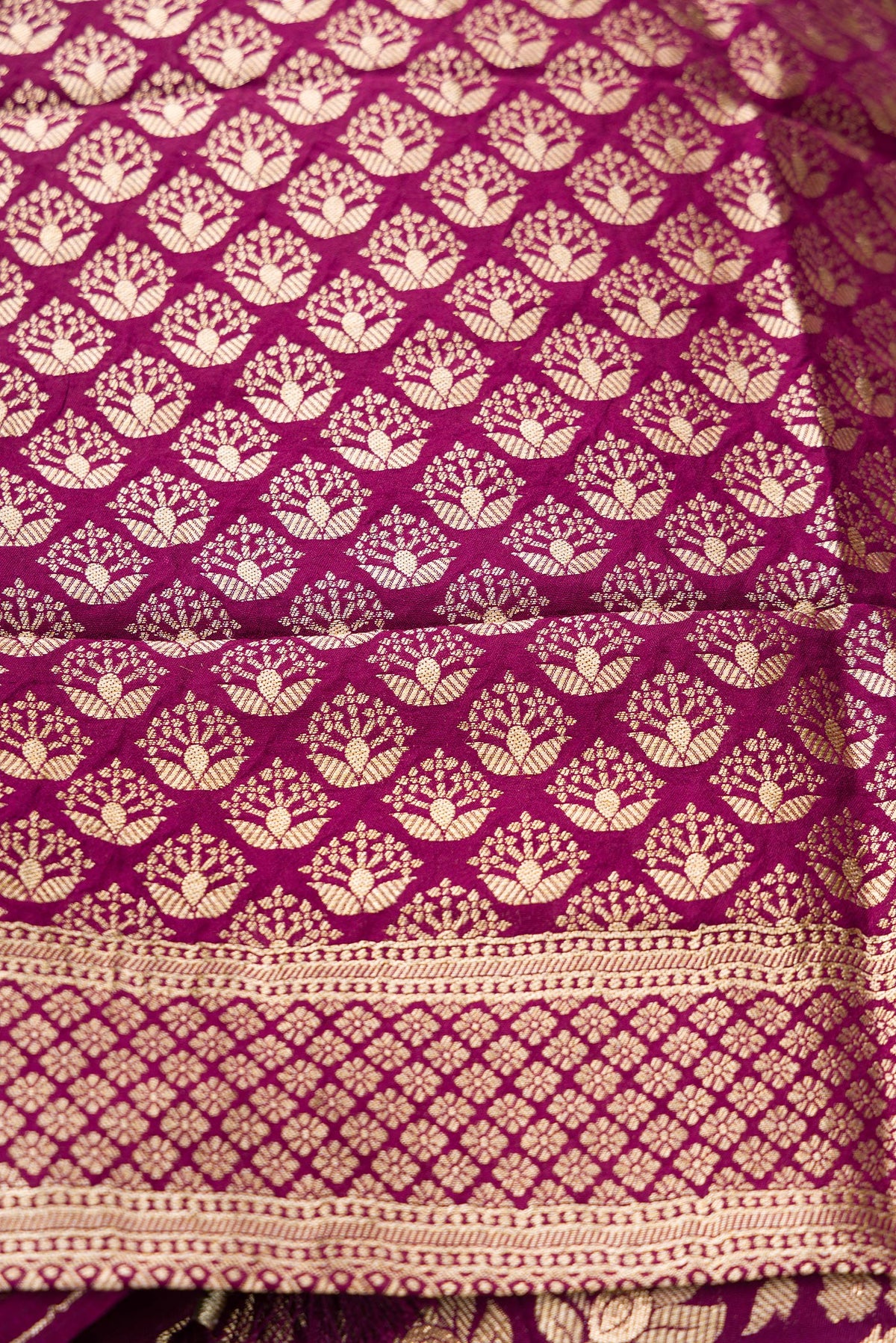 Close up blouse image of Magenta Banarasi Silk Womens Lehenga set featuring Zari Brocade Choli paired with Magenta Zari Brocade Skirt with Zari Border and a Zari Butta dupatta in Magenta