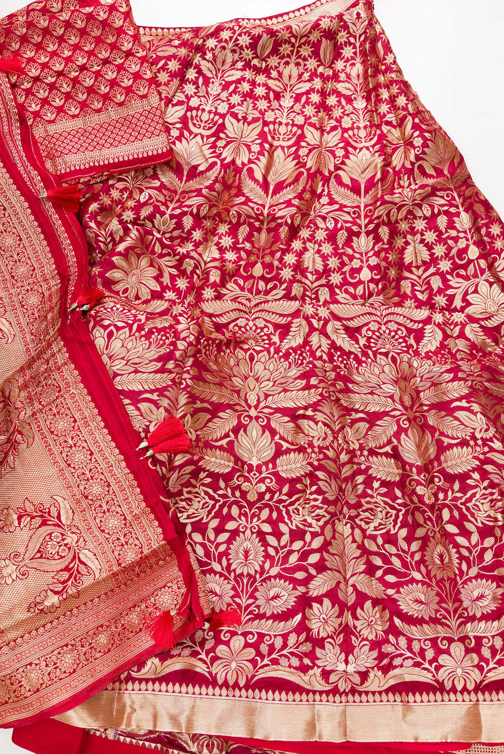 Flat lay of Imperial Red Banarasi Silk Womens Lehenga set featuring Zari Brocade Choli paired with Imperial Red Zari Brocade Skirt with Zari Border and a Zari Butta dupatta in Imperial Red