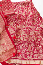 Flat lay of Imperial Red Banarasi Silk Womens Lehenga set featuring Zari Brocade Choli paired with Imperial Red Zari Brocade Skirt with Zari Border and a Zari Butta dupatta in Imperial Red