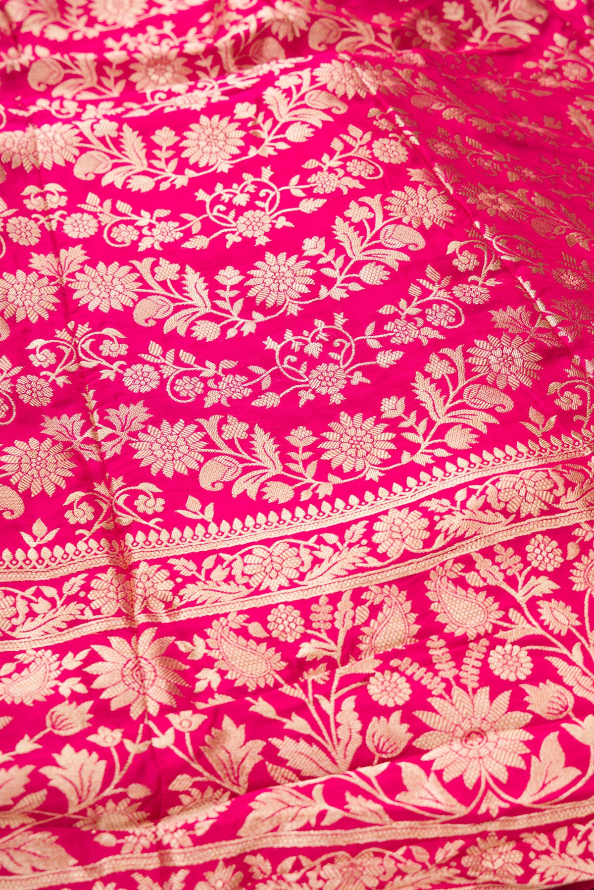 Detailed shot of Dark Pink Banarasi Silk Womens Lehenga set featuring Zari Brocade Choli paired with Dark Pink Zari Brocade Skirt with Zari Border and a Zari Butta dupatta in Dark Pink
