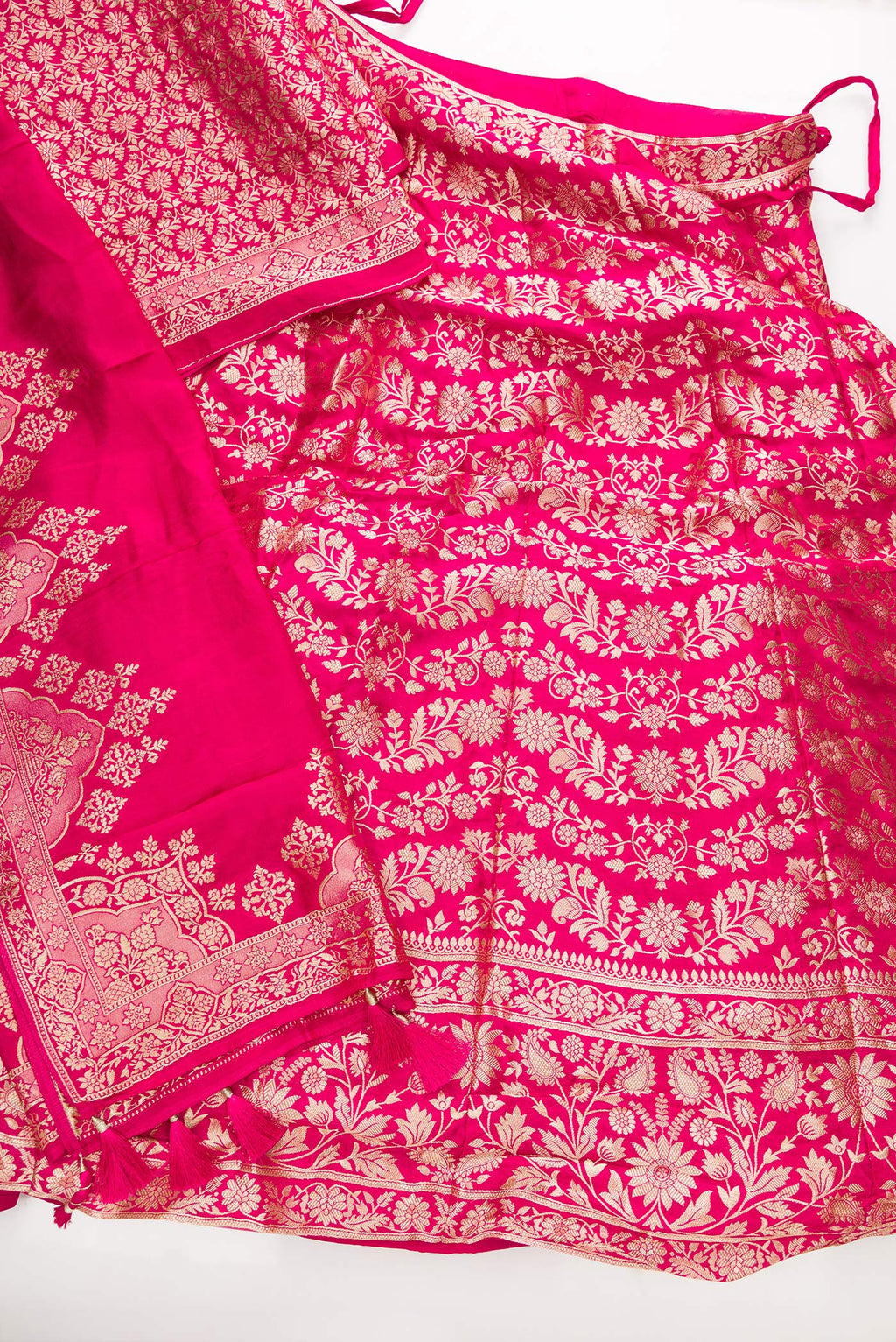 Flat lay of Dark Pink Banarasi Silk Womens Lehenga set featuring Zari Brocade Choli paired with Dark Pink Zari Brocade Skirt with Zari Border and a Zari Butta dupatta in Dark Pink