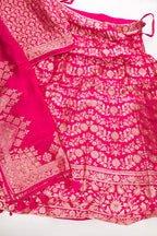 Flat lay of Dark Pink Banarasi Silk Womens Lehenga set featuring Zari Brocade Choli paired with Dark Pink Zari Brocade Skirt with Zari Border and a Zari Butta dupatta in Dark Pink