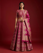 Magenta Banarasi Silk Womens Lehenga set featuring Zari Brocade Choli paired with Magenta Zari Brocade Skirt with Zari Border and a Zari Butta dupatta in Magenta