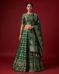 Green Banarasi Silk Womens Lehenga set featuring Zari Brocade Choli paired with Green Zari Brocade Skirt with Zari Border and a Zari Butta dupatta in Green