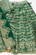 Flat lay of Green Banarasi Silk Womens Lehenga set featuring Zari Brocade Choli paired with Green Zari Brocade Skirt with Zari Border and a Zari Butta dupatta in Green