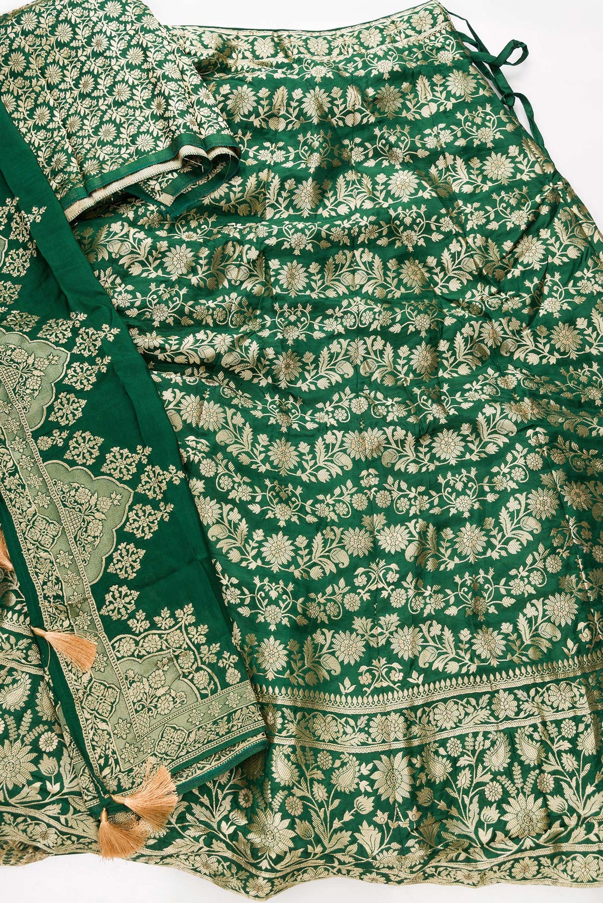 Flat lay of Green Banarasi Silk Womens Lehenga set featuring Zari Brocade Choli paired with Green Zari Brocade Skirt with Zari Border and a Zari Butta dupatta in Green