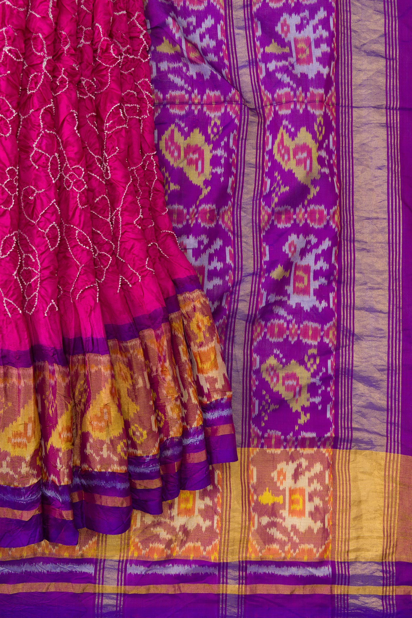 Pleats and pallu of Pink Dual Tone Bandhani Silk Saree with Bandhani Print on the body and Ikat Border. 