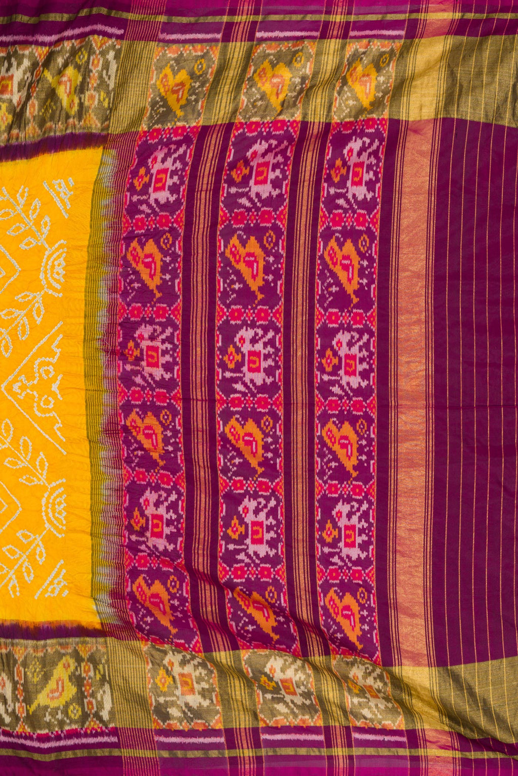 Close up image of the pallu of Yellow Dual Tone Bandhani Silk Saree with Bandhani Print on the body and Ikat Border. 