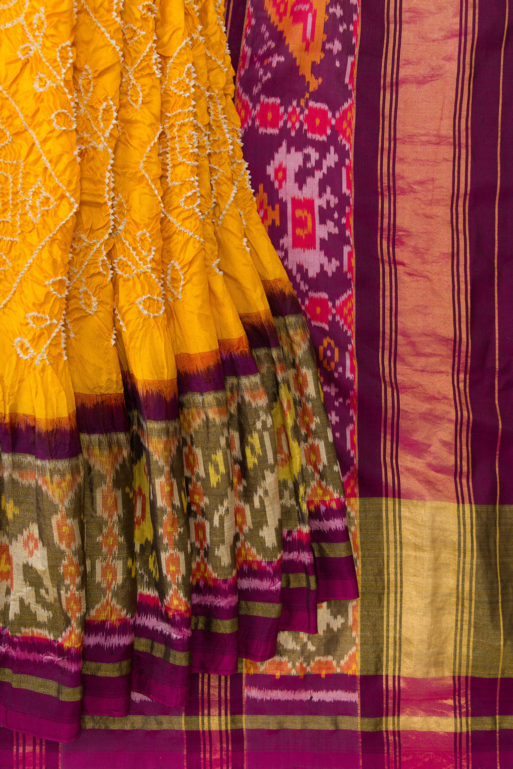 Pleats and pallu of Yellow Dual Tone Bandhani Silk Saree with Bandhani Print on the body and Ikat Border. 