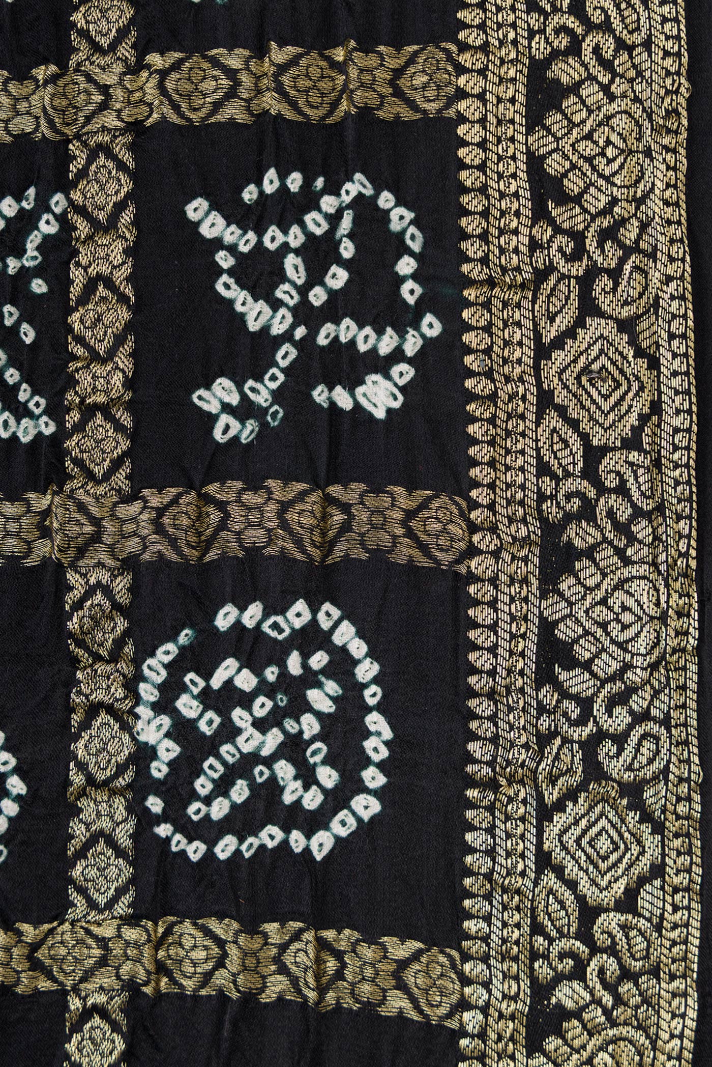 Border image of Black Dual Tone Bandhani Silk Saree with Bandhani Print on the body and Zari Border. 