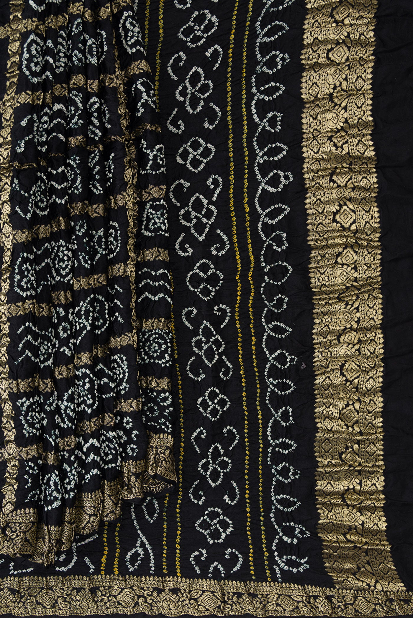 Pleats and pallu of Black Dual Tone Bandhani Silk Saree with Bandhani Print on the body and Zari Border. 