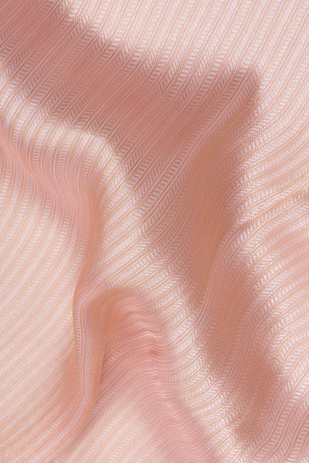 Close up of Peach Dual Tone Blended Banarasi Silk Saree with Zari Brocade on the body and Embroidered Border.  displaying folds