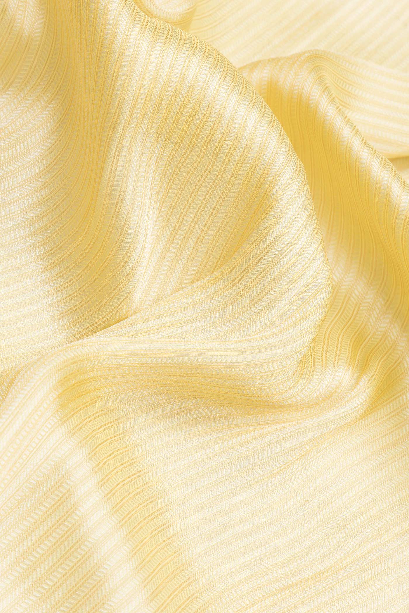 Close up of Yellow Dual Tone Mysore Georgette Saree with Zari Brocade on the body and Embroidery Border.  displaying folds