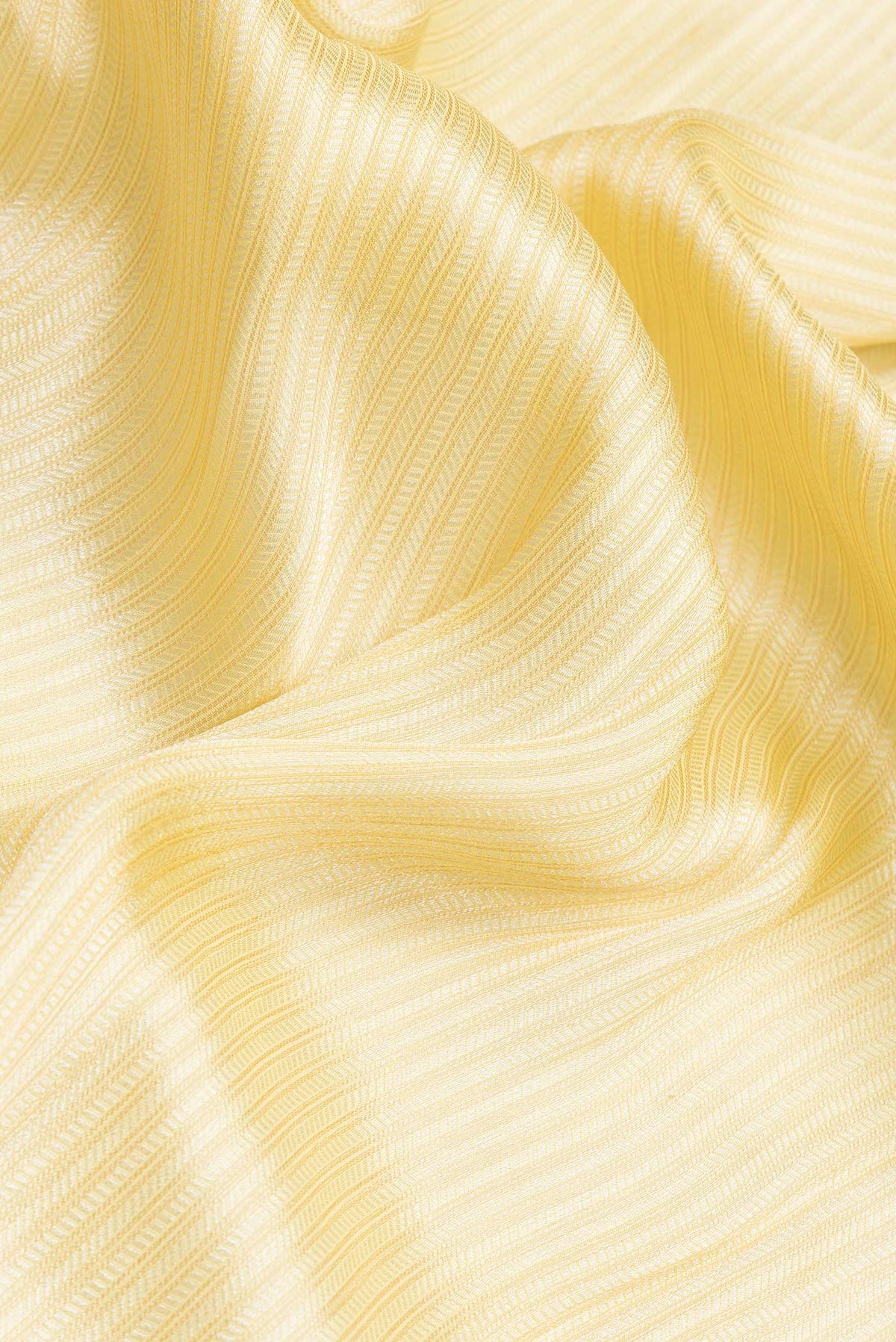 Close up of Yellow Dual Tone Mysore Georgette Saree with Zari Brocade on the body and Embroidery Border.  displaying folds