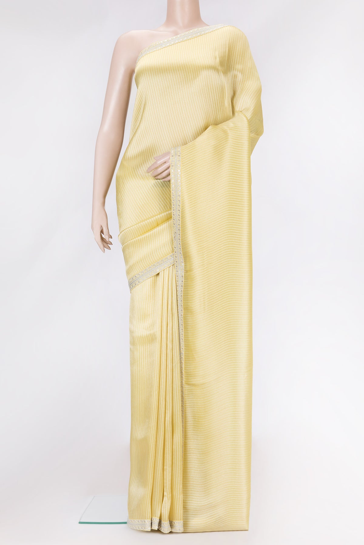 Yellow Dual Tone Mysore Georgette Saree with Zari Brocade on the body and Embroidery Border.  displayed on a mannequin