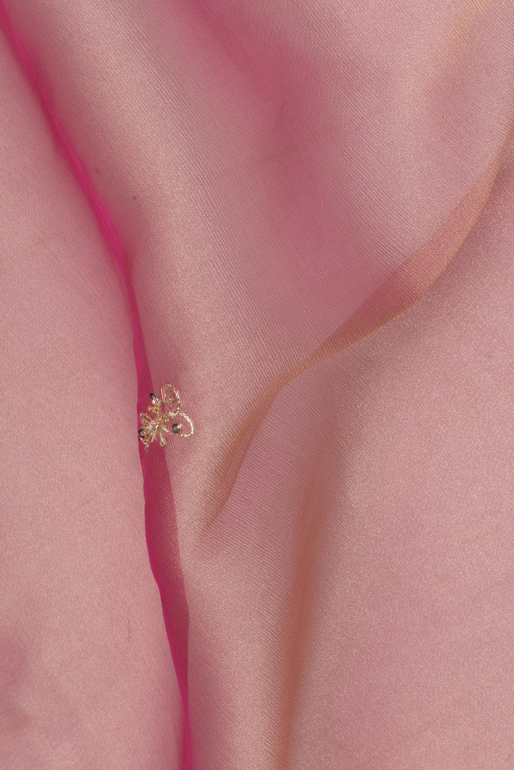 Close up of Pink Dual Tone Organza Saree with Embroidery on the body and Embroidery Border.  displaying folds