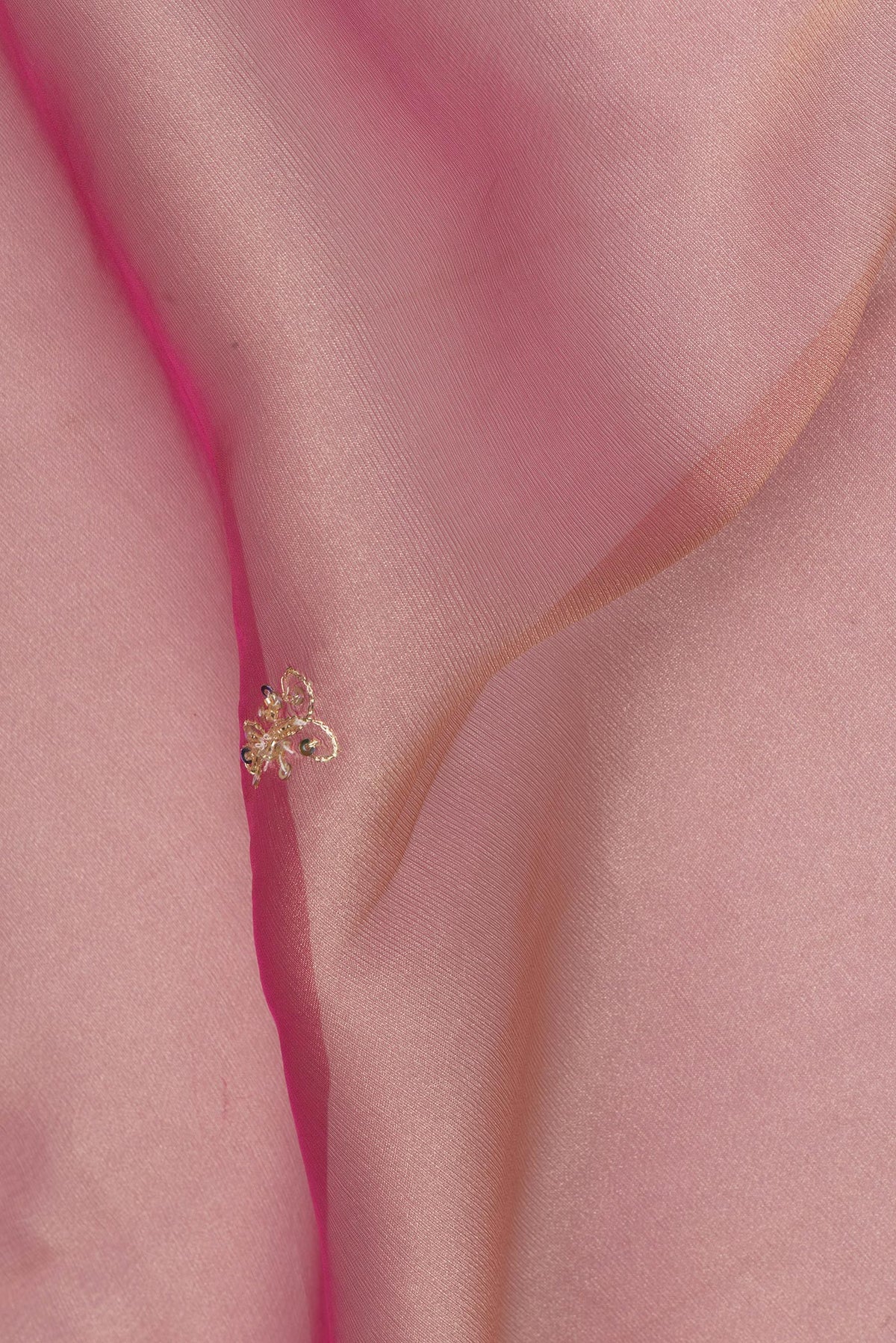 Close up of Pink Dual Tone Organza Saree with Embroidery on the body and Embroidery Border.  displaying folds