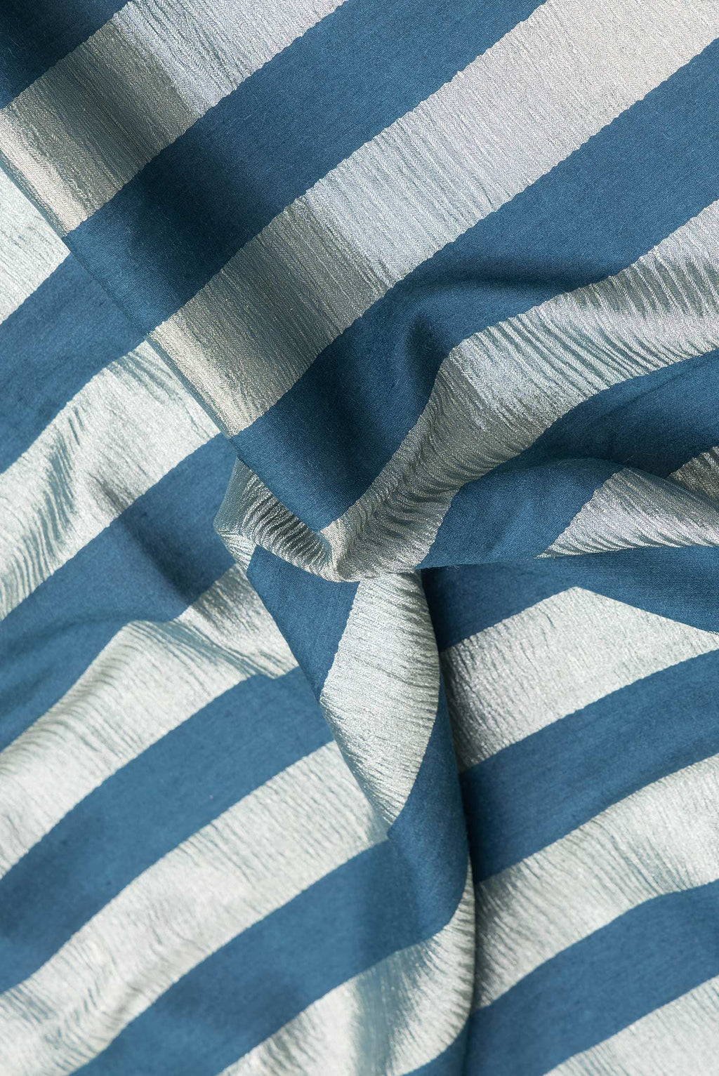 Close up of Peacock Blue Dual Tone Tussar Silk Saree with Stripes on the body and Zari Border.  displaying folds