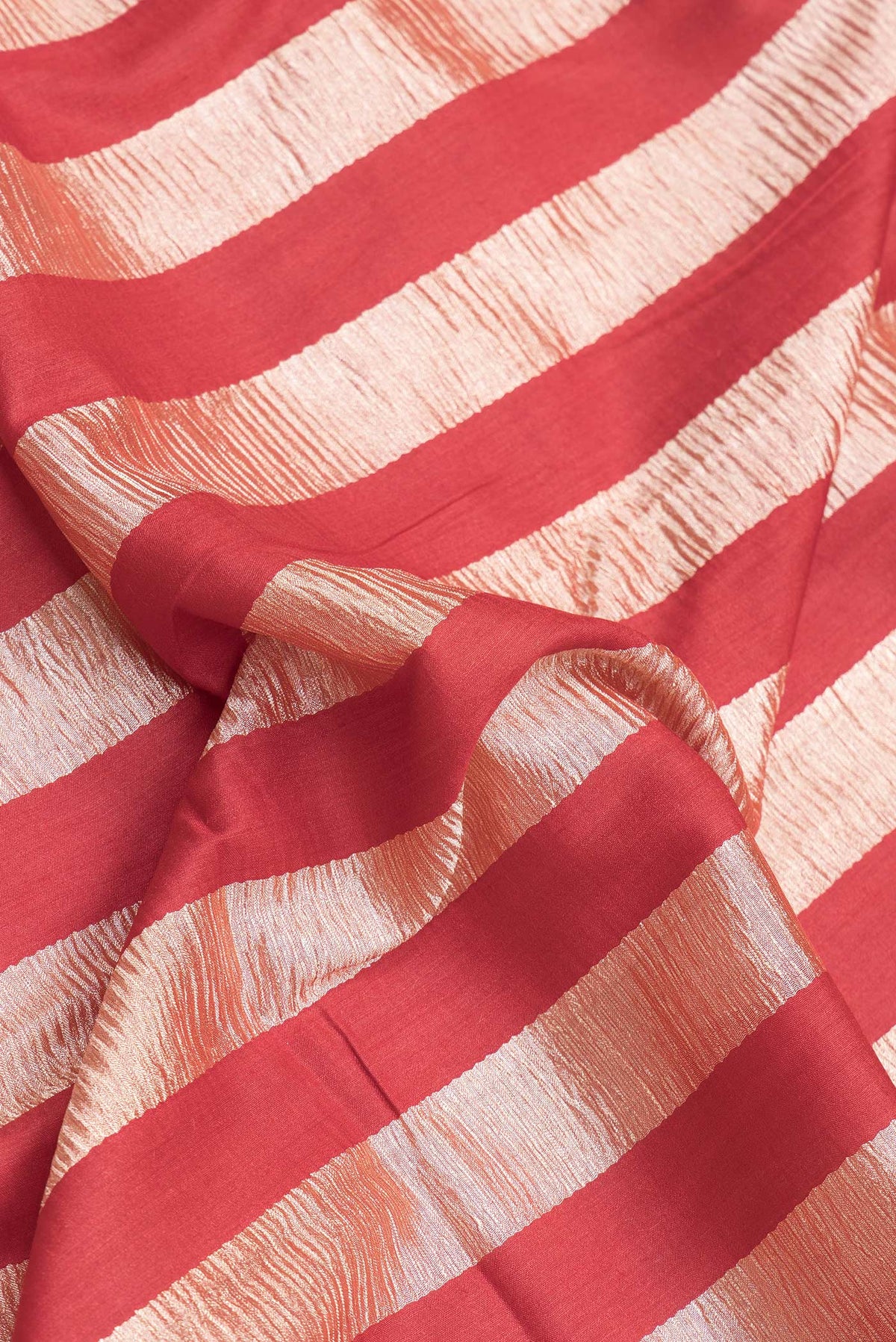 Close up of Red Dual Tone Tussar Silk Saree with Stripes on the body and Zari Border.  displaying folds