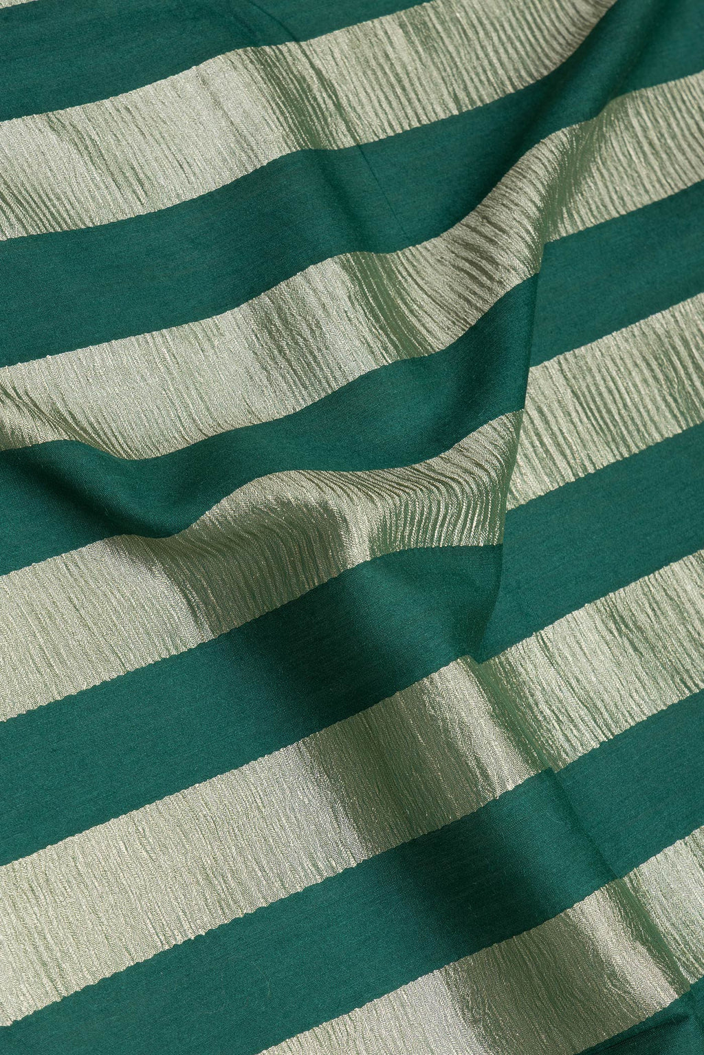 Close up of Green Tussar Silk Saree with Stripes on the body and Zari Border.  displaying folds