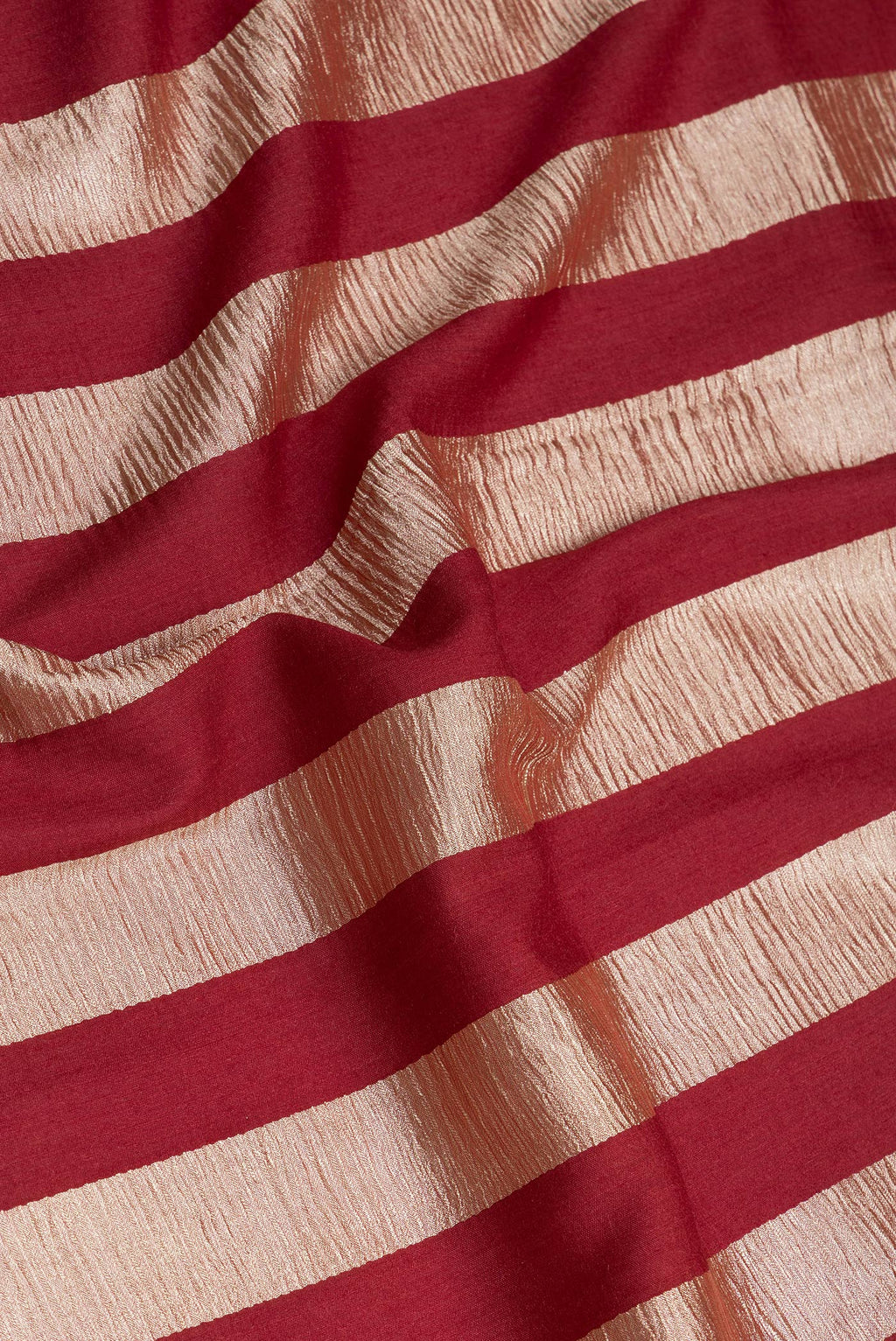 Close up of Maroon Dual Tone Tussar Silk Saree with Stripes on the body and Zari Border.  displaying folds