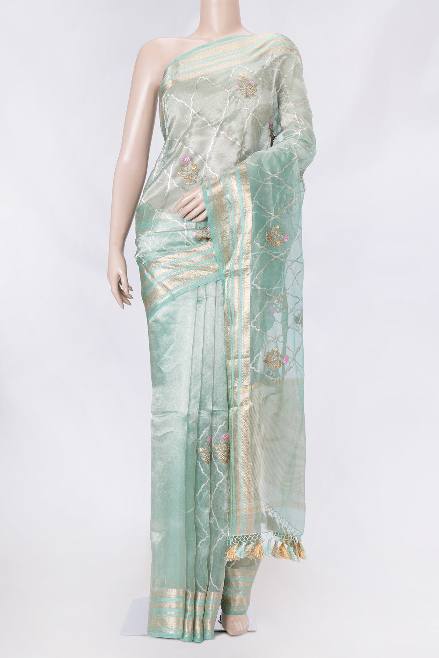 Light Blue Organza Silk Saree with Embroidery on the body and Zari Border displayed on a mannequin