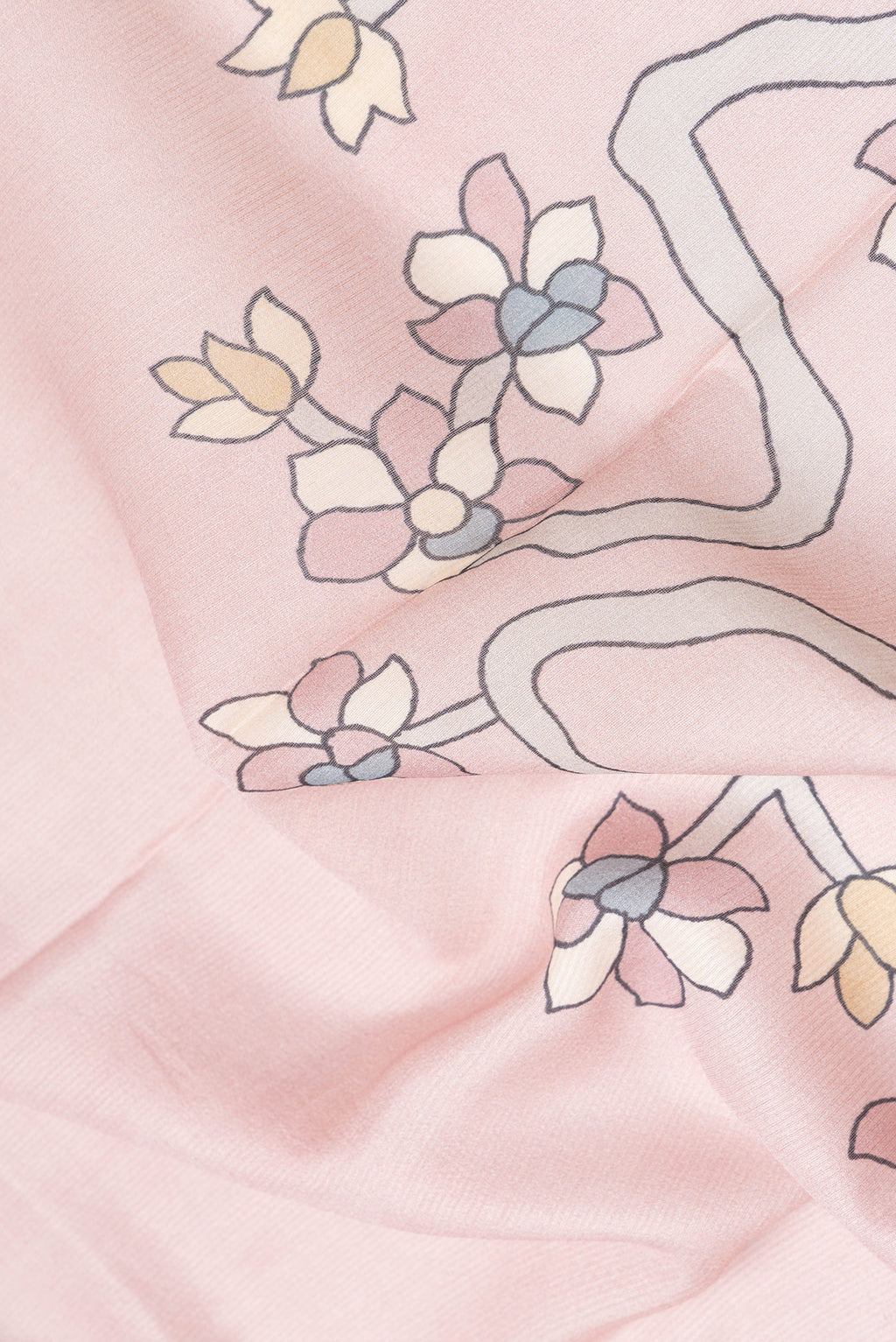 Close up of Rose Gold Dual Tone Tussar Silk Saree with Printed design on the body and Zari Border.  displaying folds