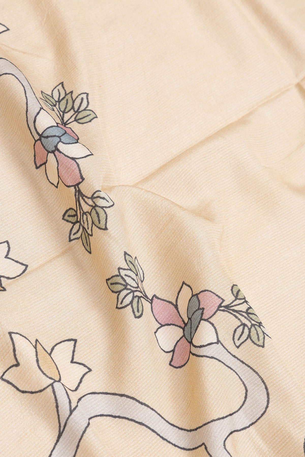 Close up of Beige Dual Tone Tussar Silk Saree with Printed design on the body and Zari Border.  displaying folds
