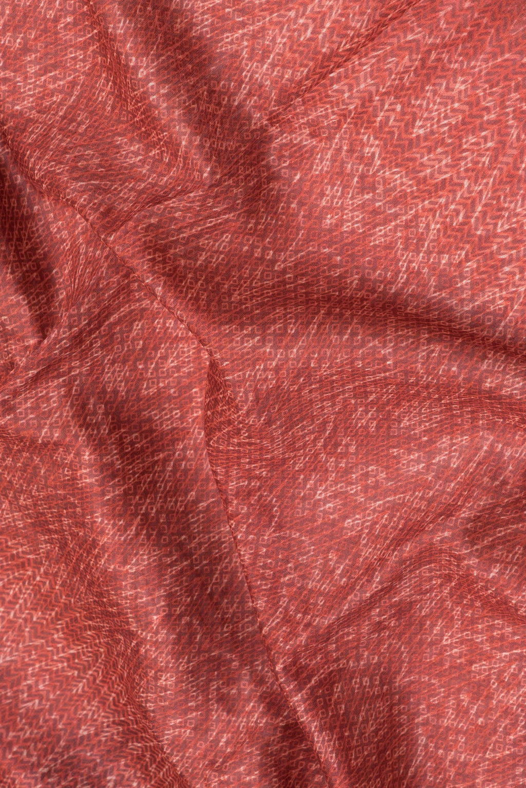 Close up of Red Dual Tone Chanderi Silk Saree with Printed design on the body and Fancy Border.  displaying folds
