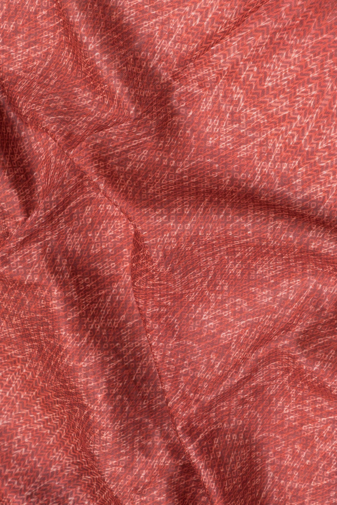 Close up of Red Dual Tone Chanderi Silk Saree with Printed design on the body and Fancy Border.  displaying folds