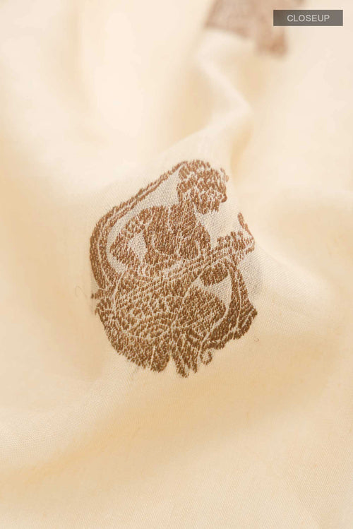 Close up of Beige Tussar Silk Saree with Thread Butta on the body and Thread Border displaying folds