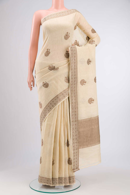 Beige Tussar Silk Saree with Thread Butta on the body and Thread Border displayed on a mannequin