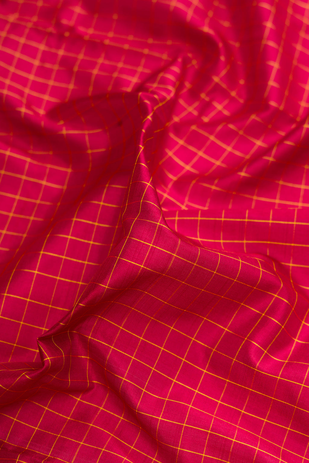Close up of Maroon Kanchipuram Silk Nine Yards Saree with Checked design on the body and Zari Border.  displaying folds