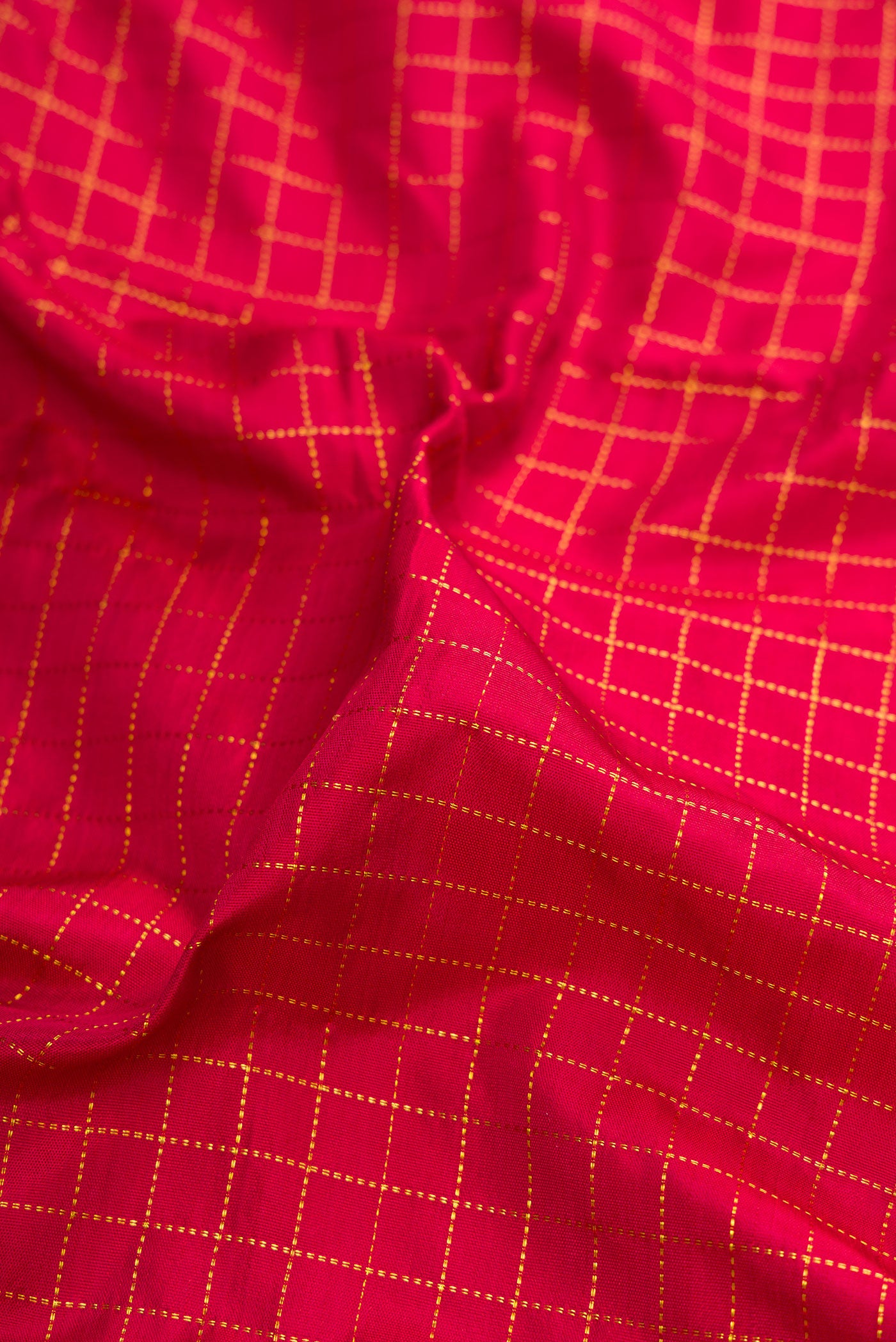 Close up of Maroon Kanjivaram Silk Nine Yards Saree with Checked design on the body and Zari Border.  displaying folds