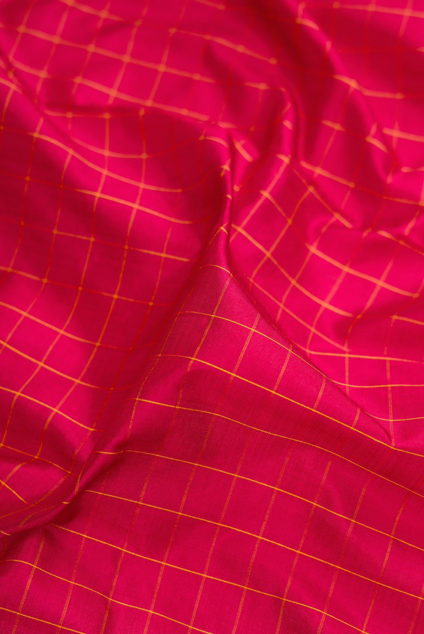 Close up of Maroon Kanchipuram Silk Nine Yards Saree with Checked design on the body and Zari Border.  displaying folds